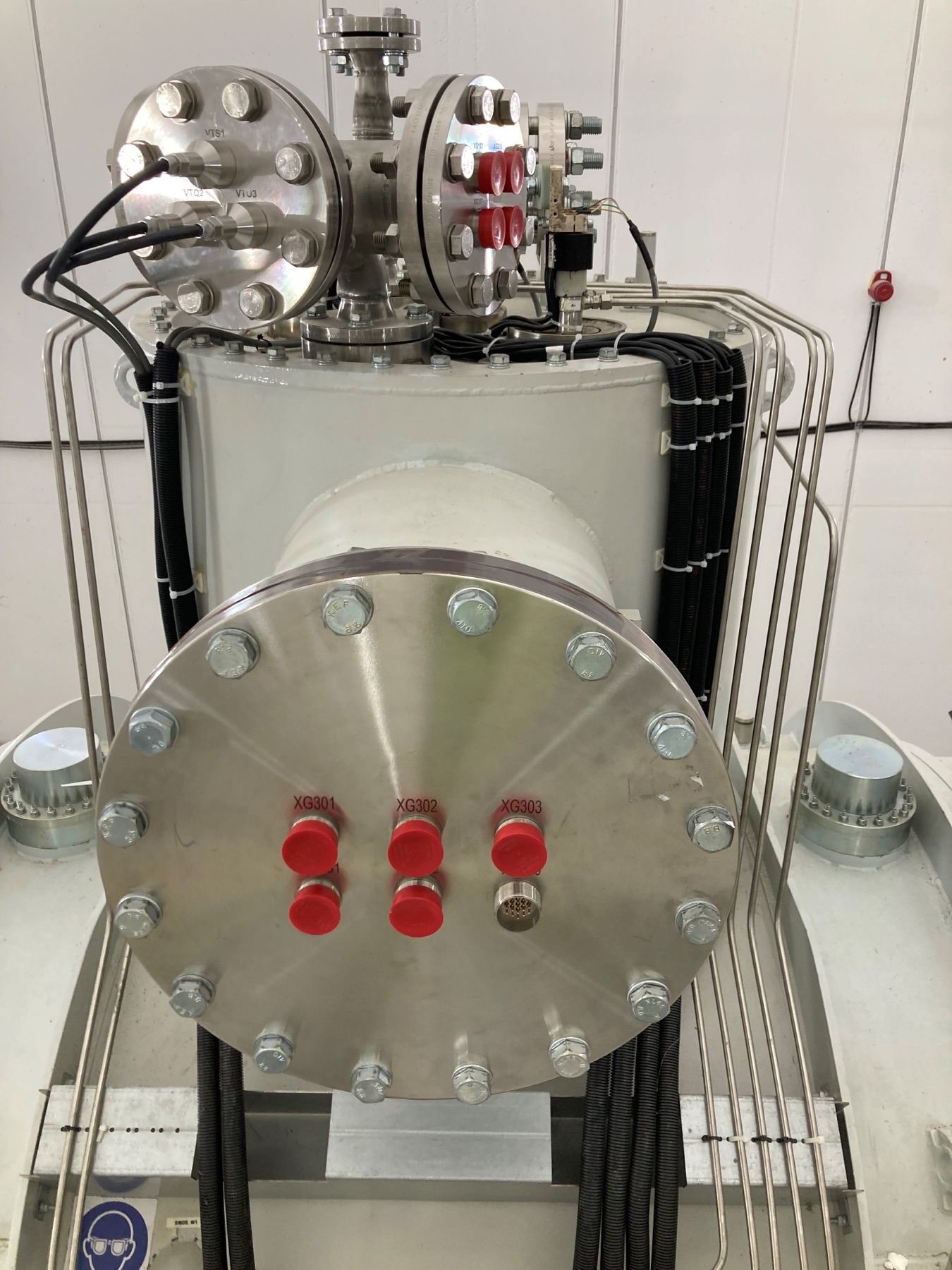 VAC-TRON hermetic feedthroughs on a stainless steel interface flange of a Super-FRS cryostat turret, with engraved connector positions XG301, XG302 and XG303